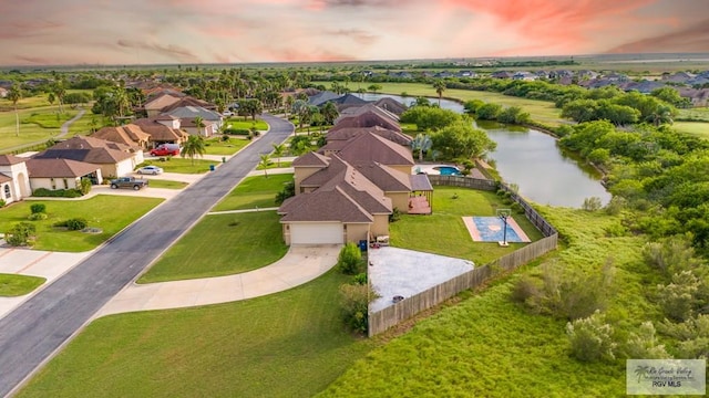 aerial view at dusk with a water view