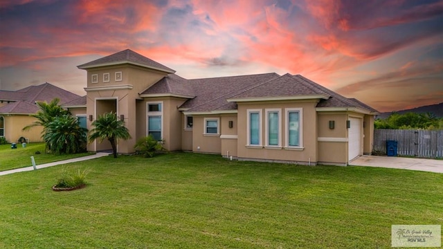 view of front of house featuring a lawn and a garage