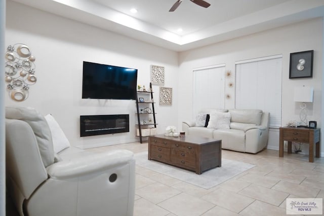 tiled living room featuring ceiling fan