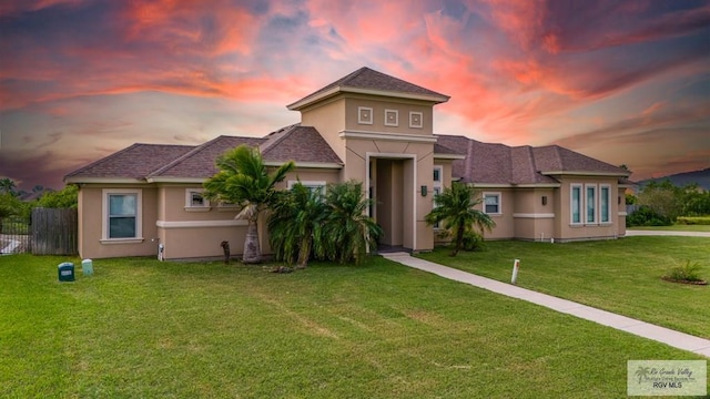 view of front of property with a lawn