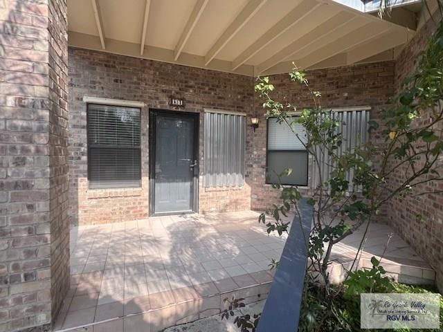 77 Santa Isabel Blvd Unit K1, Laguna Vista, TX 78578 - property entrance with brick siding and a patio