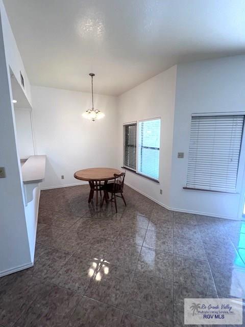 77 Santa Isabel Blvd Unit K1, Laguna Vista, TX 78578 - dining room featuring a chandelier, baseboards, and tile patterned floors