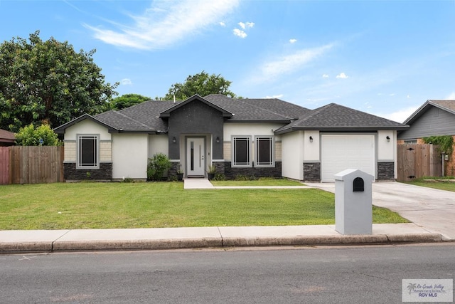 4438 Mckenzie Rd, Brownsville, TX 78521 - view of front of home with stone siding, stucco siding, concrete driveway, and an attached garage