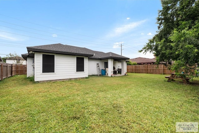 4438 Mckenzie Rd, Brownsville, TX 78521 - rear view of house with a fenced backyard and a shingled roof