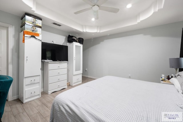 4438 Mckenzie Rd, Brownsville, TX 78521 - bedroom with a raised ceiling, light wood-type flooring, recessed lighting, and a ceiling fan