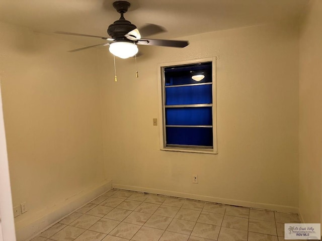 empty room with light tile patterned floors and ceiling fan