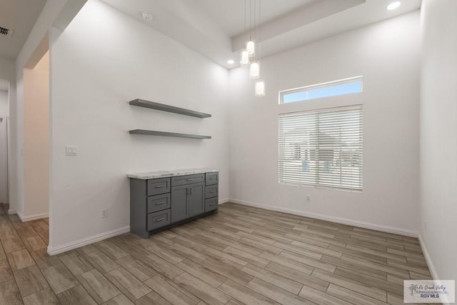 unfurnished dining area with baseboards, recessed lighting, visible vents, and light wood-style floors