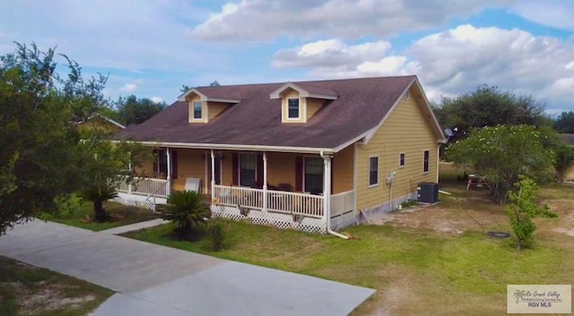 view of front of property with covered porch, central air condition unit, and a front yard