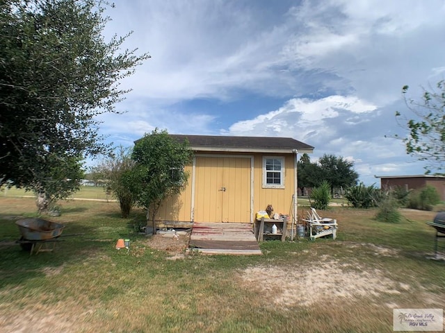 view of outbuilding with a yard