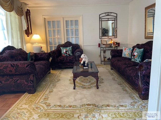 living room with crown molding, french doors, and parquet flooring