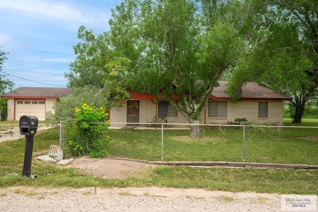 19863 Tilden Rd, San Benito, TX 78586 - obstructed view of property with brick siding and a garage