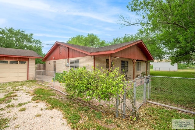 19863 Tilden Rd, San Benito, TX 78586 - view of property exterior featuring brick siding, a gate, and driveway