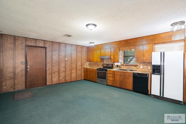 19863 Tilden Rd, San Benito, TX 78586 - kitchen featuring gas stove, dishwasher, white refrigerator with ice dispenser, a sink, and brown cabinets
