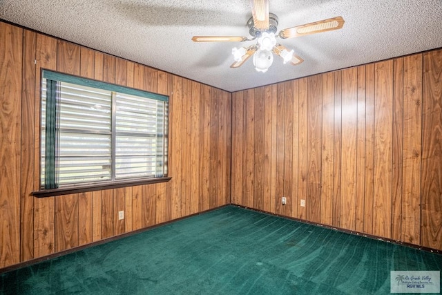 19863 Tilden Rd, San Benito, TX 78586 - empty room with a textured ceiling, carpet, wooden walls, and ceiling fan
