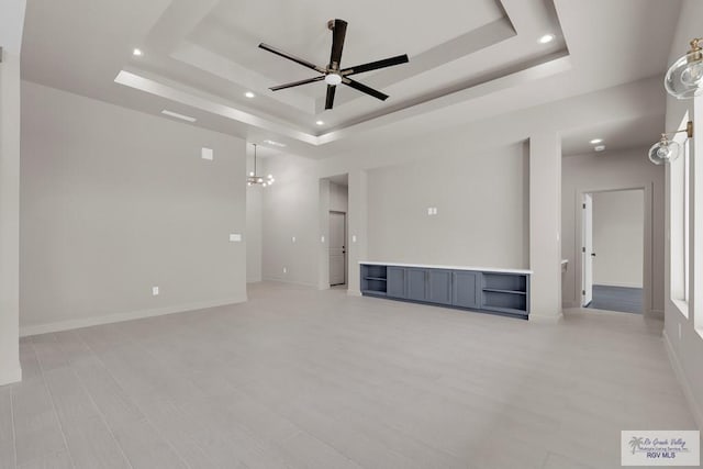 empty room featuring recessed lighting, baseboards, a raised ceiling, and a ceiling fan