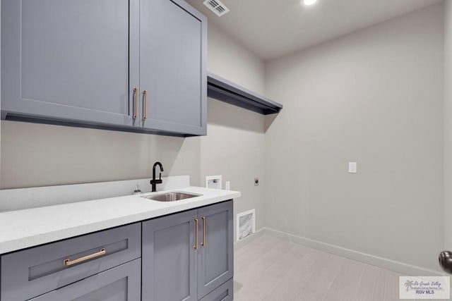 laundry area with visible vents, washer hookup, cabinet space, hookup for an electric dryer, and a sink