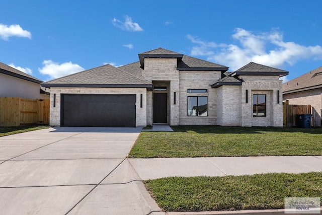 view of front facade with a front lawn, concrete driveway, a garage, and fence