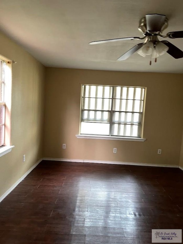 408 W 6th St, La Feria, TX 78559 - empty room with healthy amount of natural light, ceiling fan, and dark wood finished floors