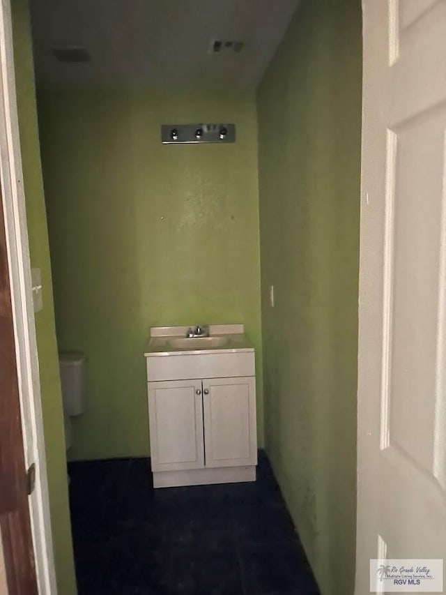 bathroom featuring vanity and toilet