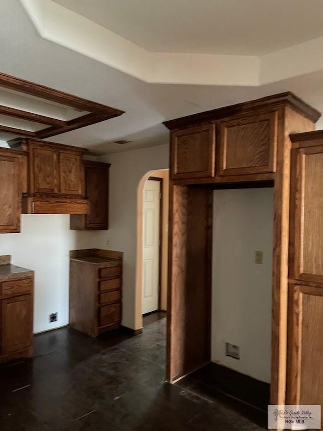 408 W 6th St, La Feria, TX 78559 - kitchen featuring arched walkways and brown cabinets