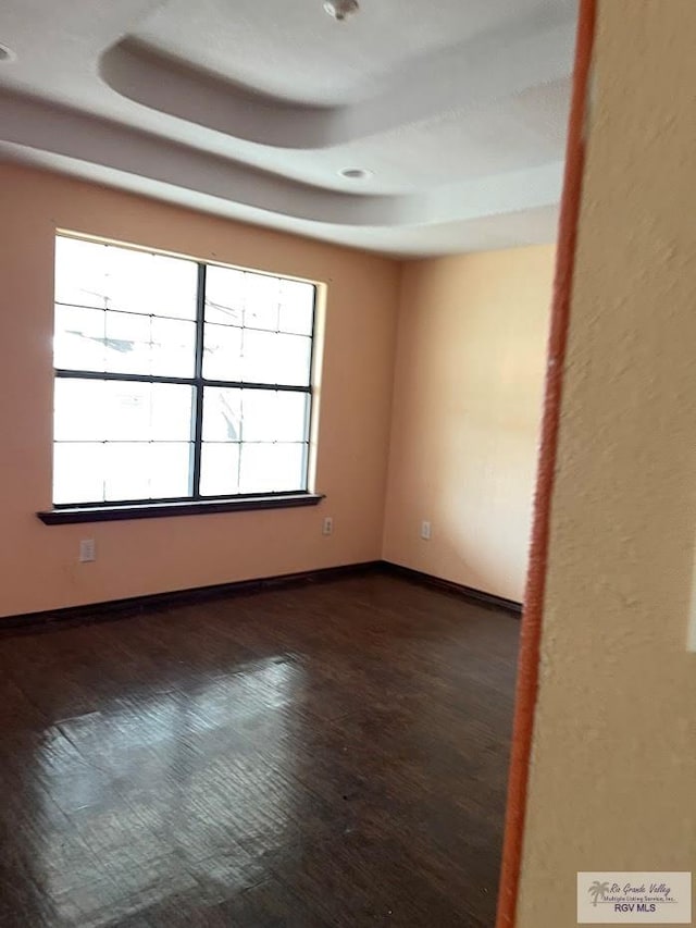 spare room featuring dark hardwood / wood-style floors