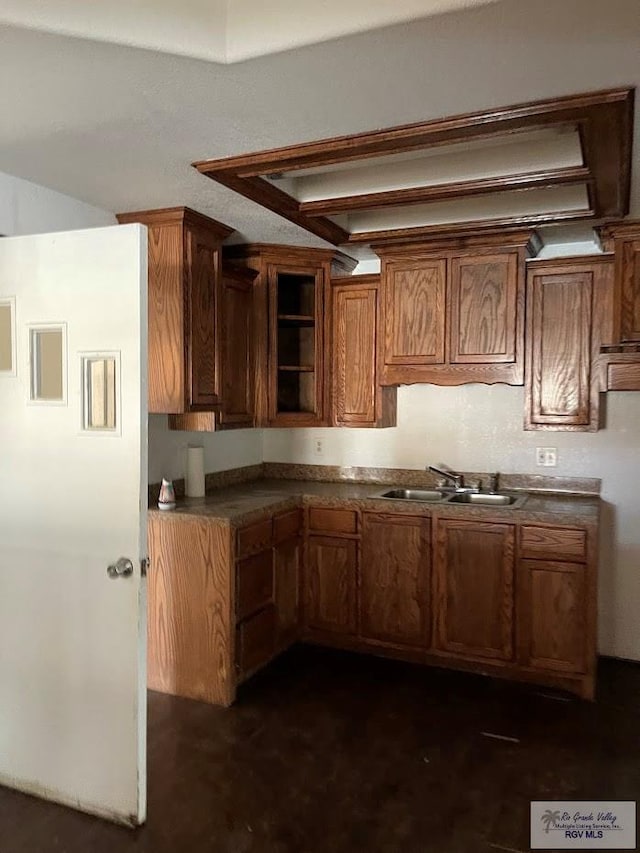 408 W 6th St, La Feria, TX 78559 - kitchen featuring brown cabinets and dark countertops