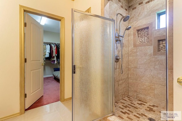 bathroom featuring tile patterned flooring and a shower with shower door