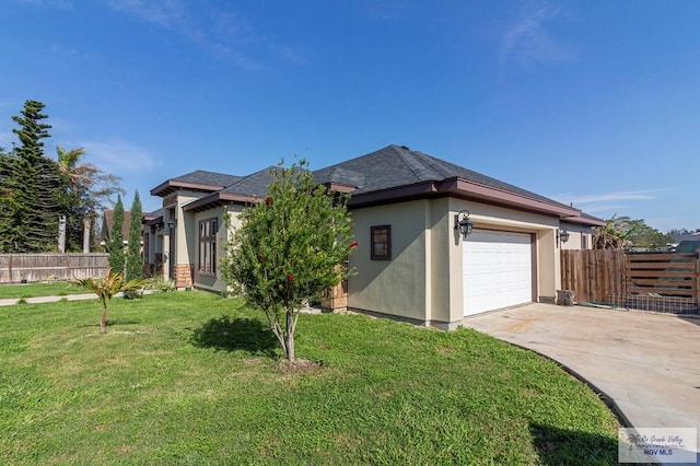 view of front of property with a front yard and a garage