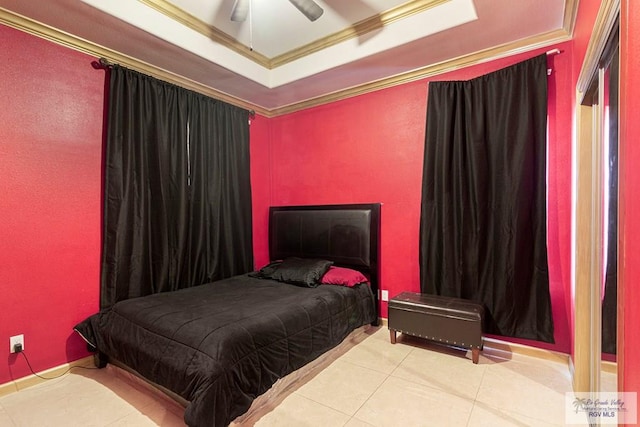 tiled bedroom with a tray ceiling, ceiling fan, and ornamental molding