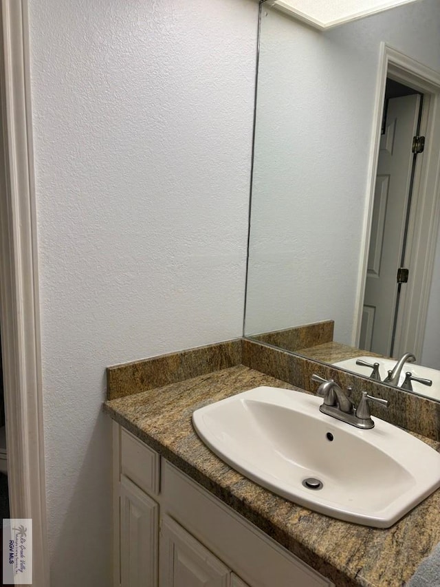 810 E Robin Ave Unit 53, Harlingen, TX 78550 - bathroom with vanity and a textured wall