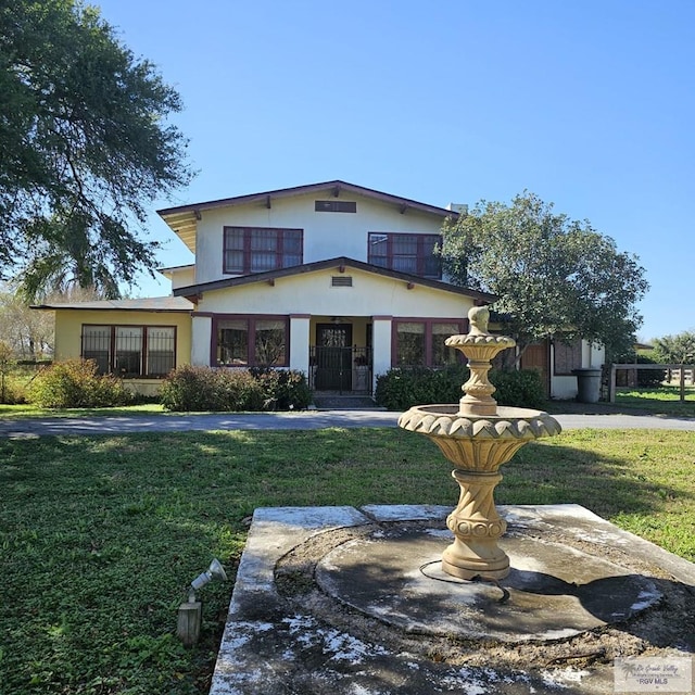 view of front facade featuring a front yard and stucco siding