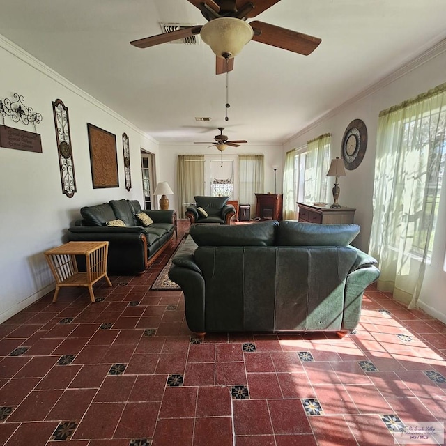 living room with baseboards, visible vents, and ornamental molding