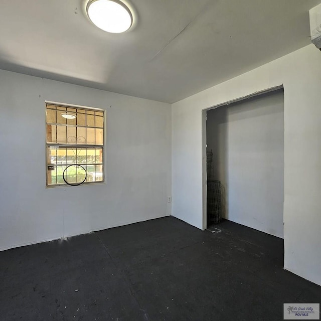 empty room with unfinished concrete flooring