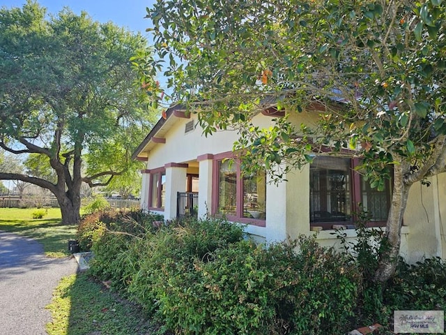 view of side of property with stucco siding