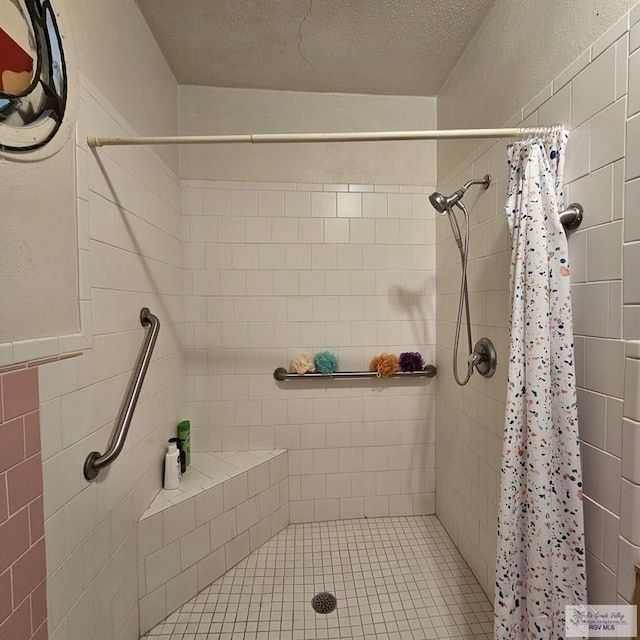 bathroom featuring a stall shower and a textured ceiling