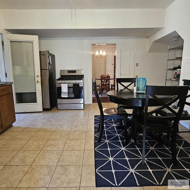 dining space with an inviting chandelier and light tile patterned flooring