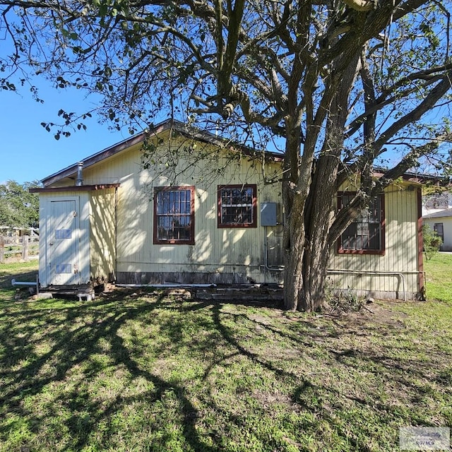 view of side of home featuring a yard