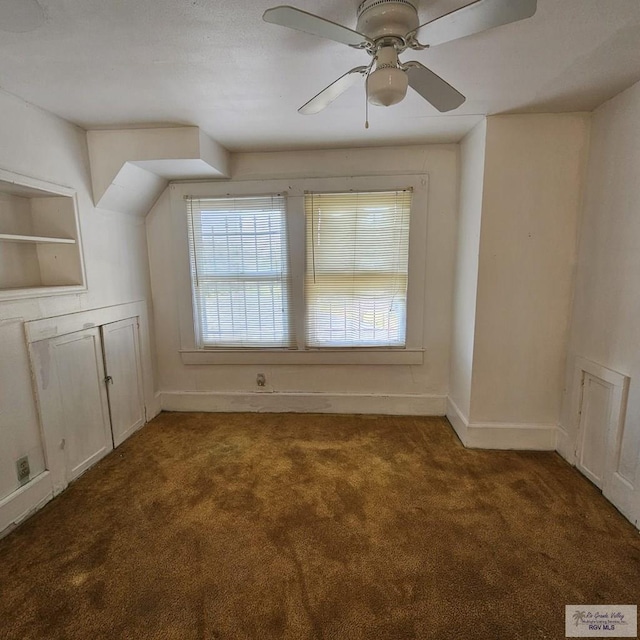 bonus room with carpet floors, ceiling fan, and baseboards