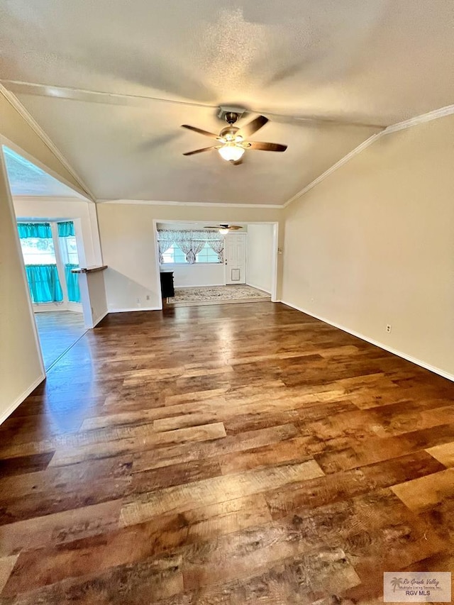 unfurnished living room featuring baseboards, ceiling fan, ornamental molding, and wood finished floors