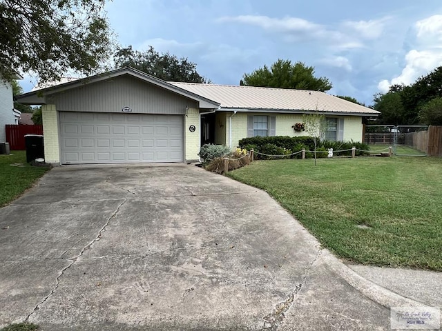 ranch-style house featuring driveway, metal roof, fence, a front lawn, and brick siding