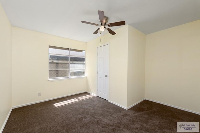 unfurnished bedroom with ceiling fan, dark carpet, and a closet