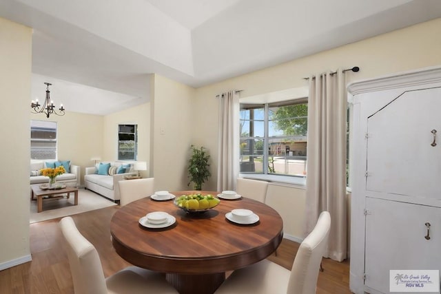 dining room featuring a notable chandelier and light hardwood / wood-style floors