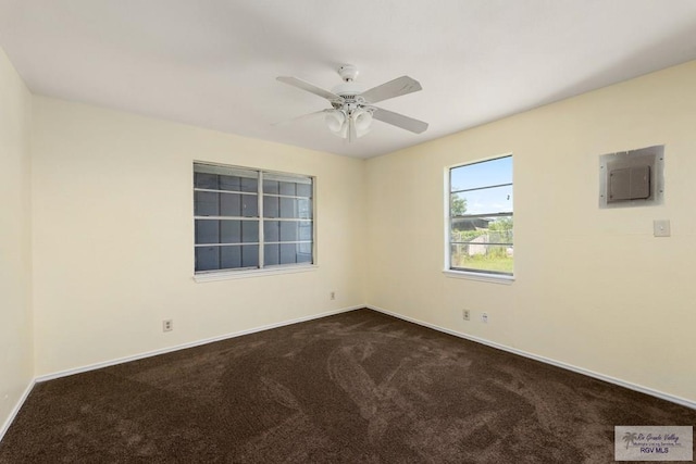 carpeted spare room with electric panel and ceiling fan