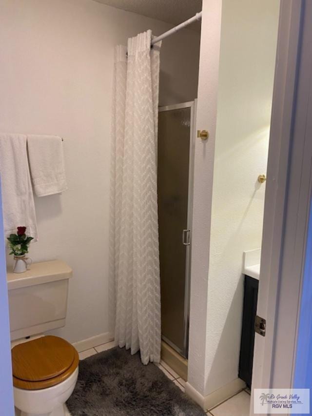 bathroom with toilet, tile patterned flooring, and walk in shower