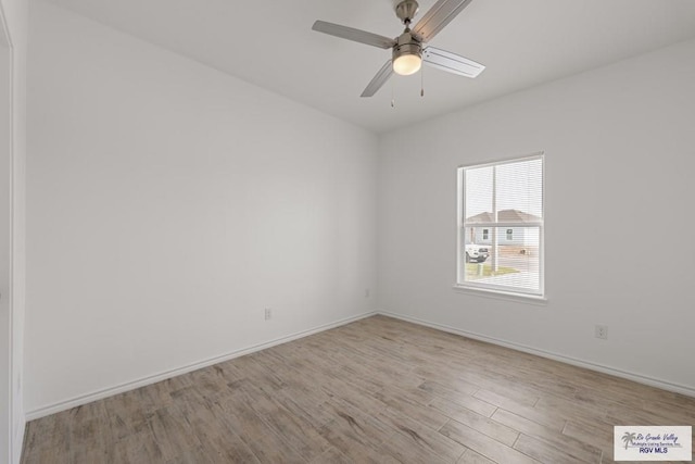 empty room with light hardwood / wood-style flooring and ceiling fan