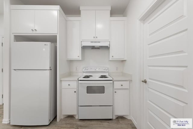 kitchen with white appliances, light hardwood / wood-style floors, and white cabinets