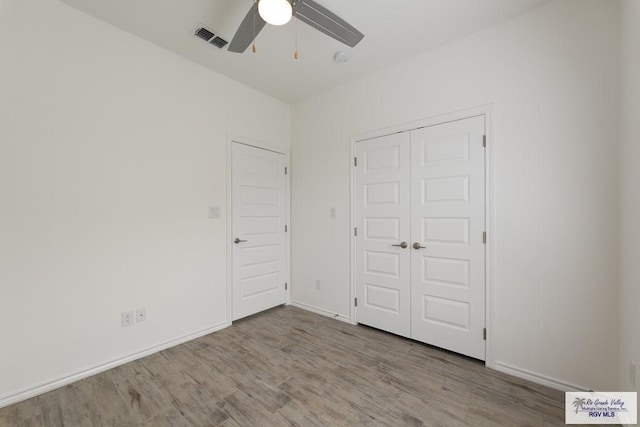 unfurnished bedroom with a closet, ceiling fan, and light hardwood / wood-style flooring