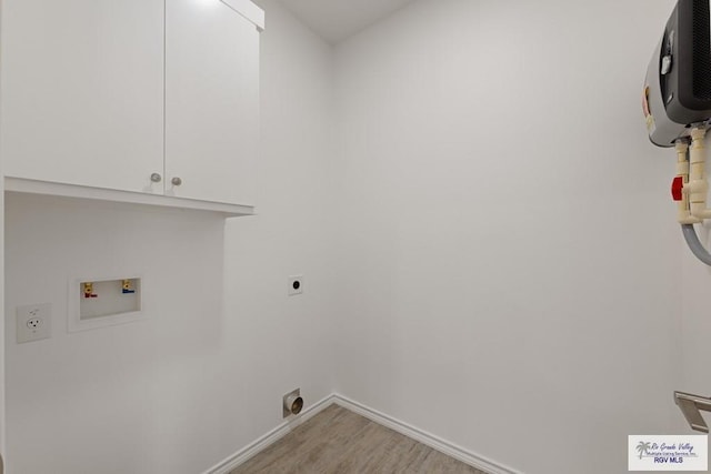 laundry area featuring light wood-type flooring, cabinets, hookup for a washing machine, and electric dryer hookup