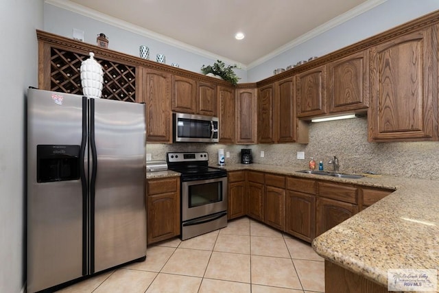 kitchen with appliances with stainless steel finishes, sink, decorative backsplash, ornamental molding, and light stone countertops