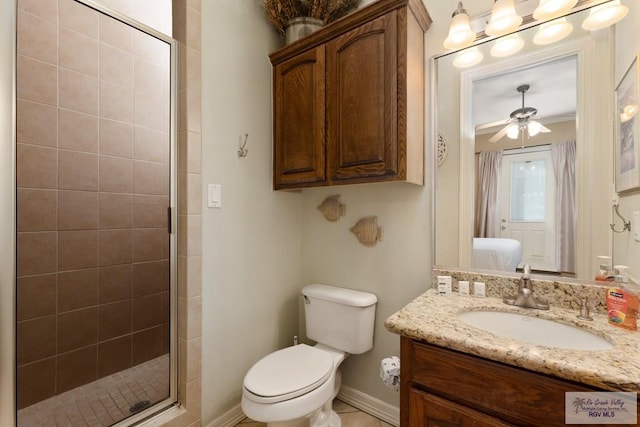 bathroom with vanity, an enclosed shower, ceiling fan, and toilet